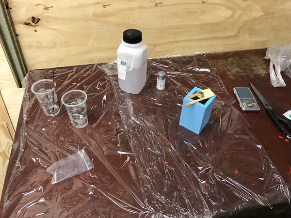 Workspace covered with plastic foil. With mould and mixing containers.
