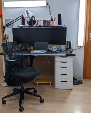 The old desk supporting my 49" widescreen monitor. Includes a short shelf above the desk. The desk surface is 150x75cm
